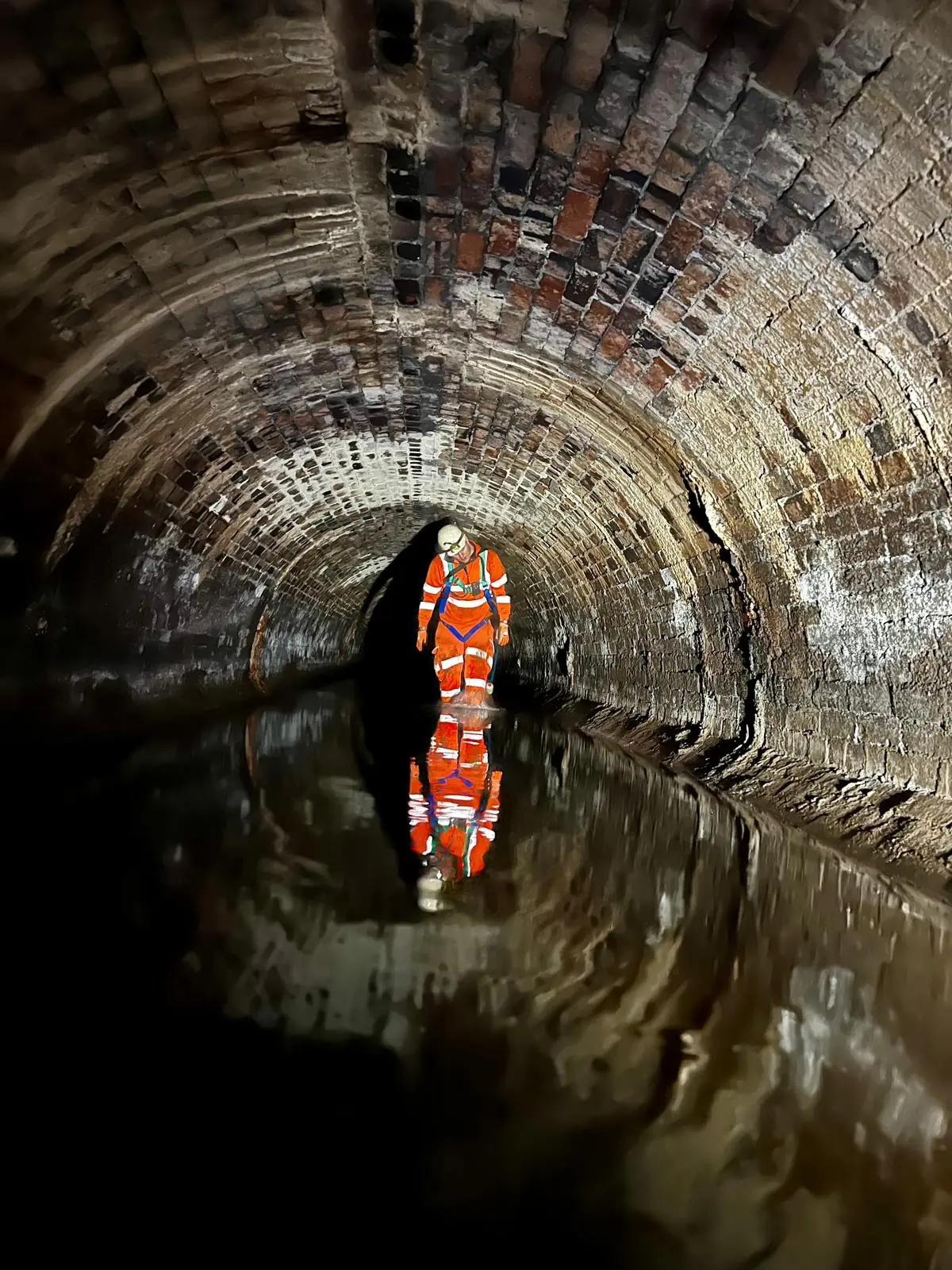 CRM operative progressing through an arched water-filled culvert under controlled entry arrangements