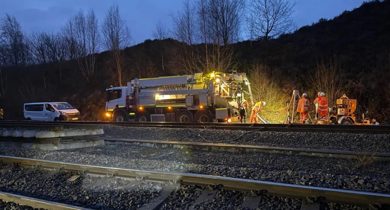 Rail-side drainage and water management works at night