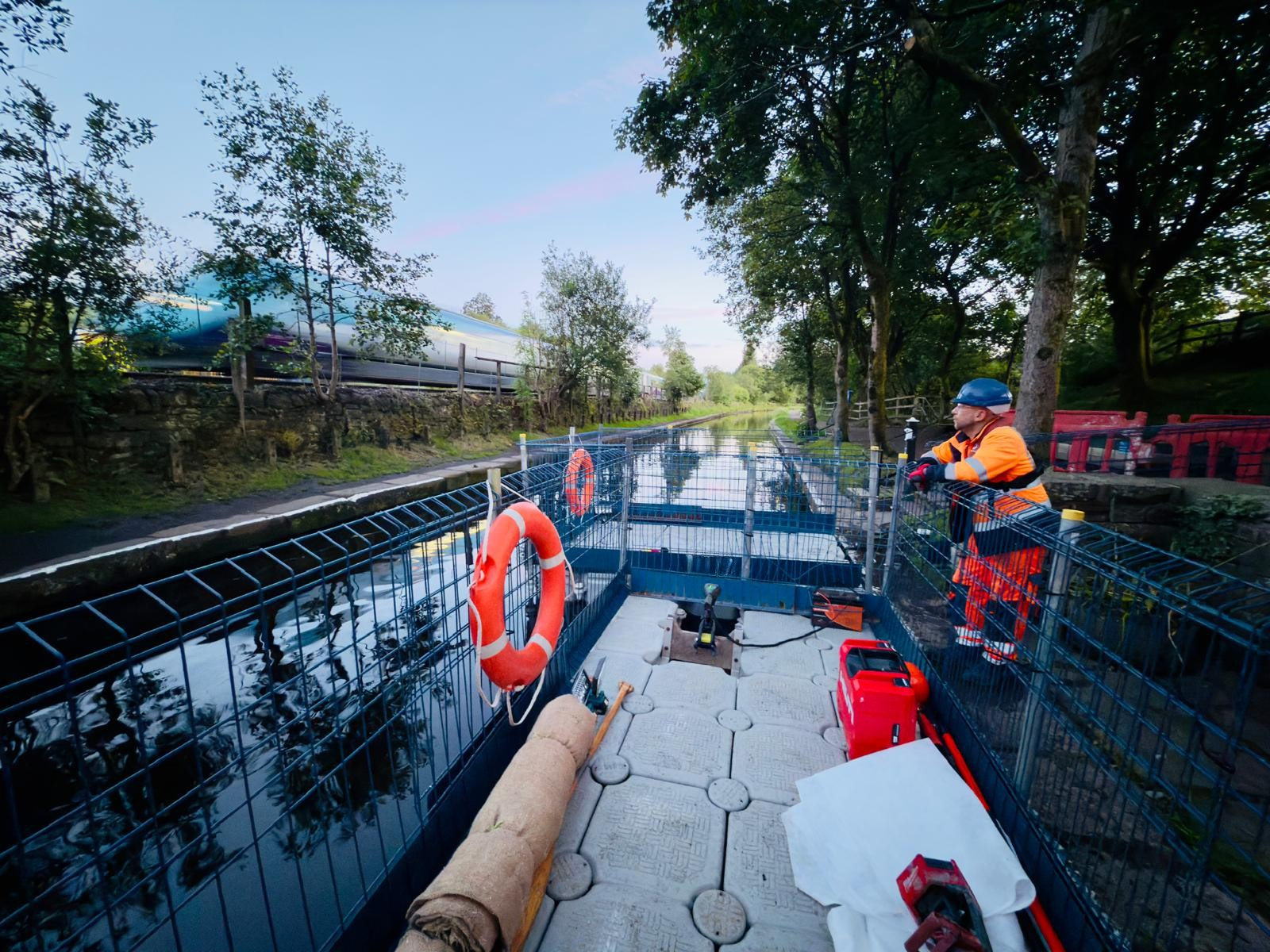 Protected modular pontoon access beside railway infrastructure